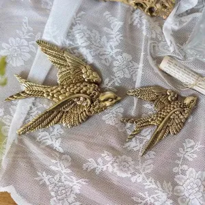 Vintage brass swallow wall decor detail, exquisite wing texture for elegant home styling.