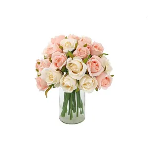 Artificial silk rose bouquet in clear glass vase fake flowers for wedding home decor piece.