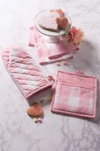 Detailed view of the pink and white plaid oven mitt and potholder set, perfect for baking.