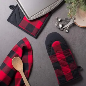 Red and black buffalo plaid oven mitts and potholder set detail for kitchen baking.