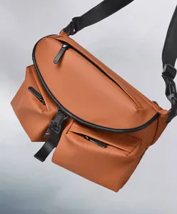 Close-up detail of waterproof brown men chest bag with multi zip pockets and adjustable strap.