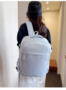 Detailed view of the light grey waterproof commuter backpack showing zipper and fabric texture.