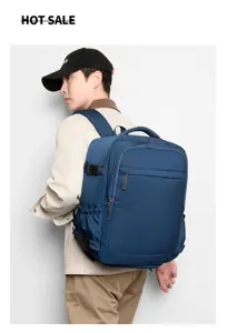 Detailed view of dark blue business travel backpack worn by model, showing side straps.