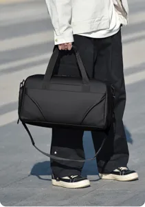 Men's large capacity black shoulder duffel bag, casual travel messenger handbag detail.
