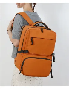 Orange large capacity travel backpack worn by model showing multi compartments and durable straps.