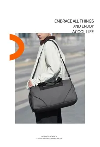 Outdoor detail view showcasing the large capacity grey shoulder duffel bag worn by model.