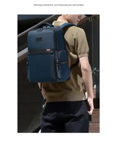 Close-up view of the dark blue business backpack worn by the model with multi-pockets.