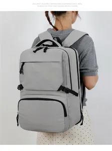 Detail shot of the large capacity grey backpack showing multi-compartment interior design.
