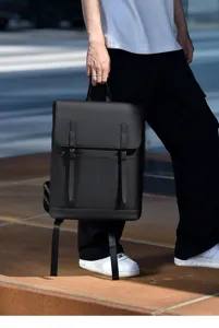 Detailed view of minimalist black men's business backpack, large capacity and casual style.