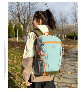 Outdoor backpack detail showing dual-tone light blue and green fabric with orange straps.