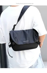 Detailed view of black oxford cloth messenger bag worn on back, showing shoulder strap and buckle.