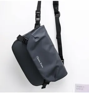 Detail shot of the dark grey waterproof crossbody bag showcasing adjustable strap and buckle.