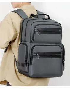 Detailed view of the multi-pocket grey business backpack showing durable fabric and zippers.