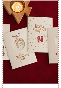 Gros plan détaillé de cartes de vœux de Noël avec dorure à chaud et design ajouré.