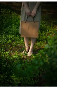 Minimalist retro kraft paper shopping bag for clothing gifts, sturdy horizontal tote bag.