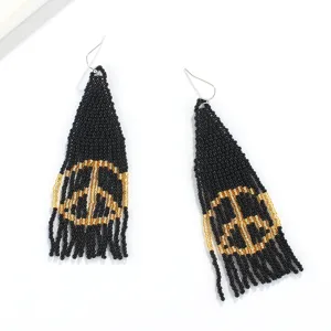 Handmade black and gold seed bead fringe earrings featuring unique bohemian peace sign style.