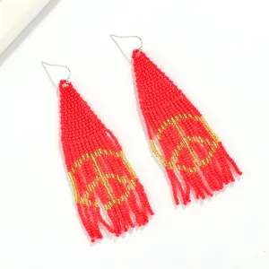 Handmade bohemian seed bead fringe earrings featuring a peace sign design and red gold style.