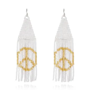 Bohemian handmade white seed bead fringe earrings with gold peace sign design for women.