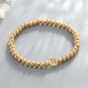 Detail view of gold stainless steel beaded zodiac bracelet with virgo charm accessory.
