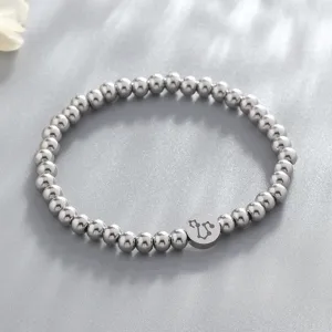 Stainless steel constellation beaded bracelet detail, stylish round charm jewelry close-up.