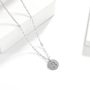 Stainless steel letter necklace detail view, minimalist pendant clavicle chain jewelry.
