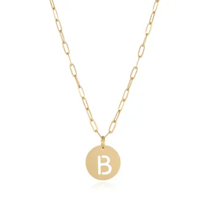 Gold paperclip chain necklace detail, cutout letter pendant, stylish fashion jewelry.