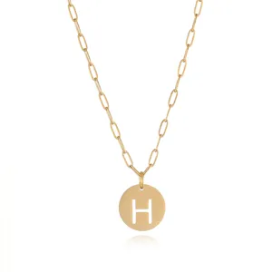 Gold stainless steel paperclip chain necklace with a circular cut out letter H pendant.