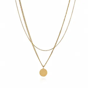 Detail shot of gold double layer letter T pendant necklace stainless steel chain closeup.
