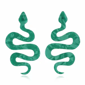 Detail shot of stylish long green acrylic snake earrings, showing unique pattern and design.