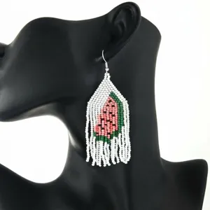 Handmade beaded watermelon fringe earrings, detailed close-up shot showing unique bohemian style.