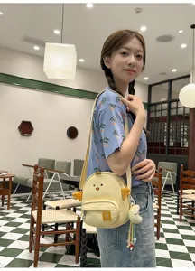 Cute cartoon chick crossbody bag detail, sweet style canvas shoulder bag for women.