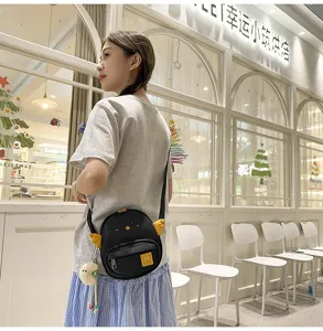 Closeup detail showing the cute chick design, yellow wings, and adjustable shoulder strap.