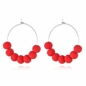 Detailed view of red clay bead hoop earrings, stylish bohemian candy color jewelry for women.