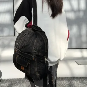 Vintage denim backpack for women, casual commuter bookbag with multiple pockets and retro design.