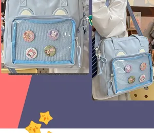 Detailed view of light blue ita bag with clear window, bear ears and cute pin badges inside.