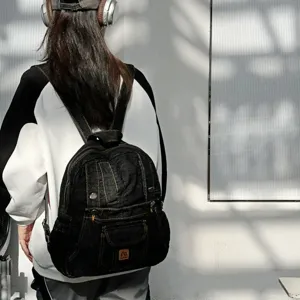 Vintage dark denim backpack for women, casual college school bag with retro design.