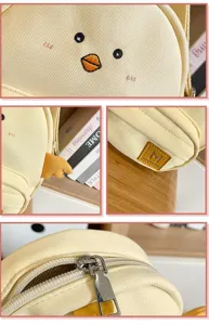 Cute cartoon yellow chick canvas crossbody bag detail shot showing cute embroidery and zipper.