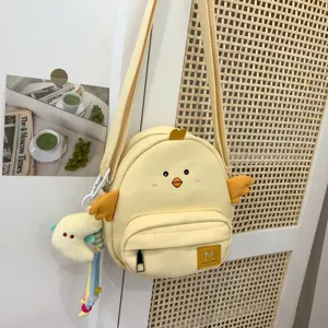 Cute cartoon chick crossbody bag detail, kawaii canvas shoulder bag for women and kids.