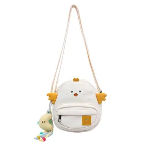 Cute cartoon chicken crossbody bag for girls, white canvas shoulder bag with plush pendant.