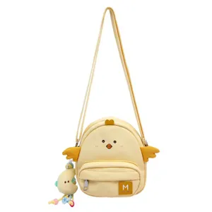 Cute yellow chick canvas crossbody bag detail, featuring 3D wings and a playful doll pendant.