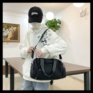 Black sports duffel bag for gym, travel, and fitness with large capacity and shoulder strap.