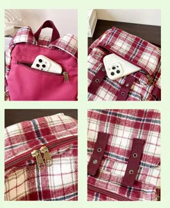 Detailed view of red plaid backpack featuring front pocket, metal zippers, and secure straps.