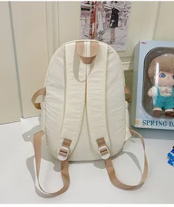 Nylon casual student backpack in solid off-white color, featuring adjustable straps and sturdy top handle.