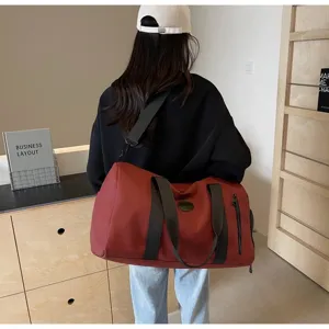 Vue détaillée du sac de voyage montrant la poche latérale et les sangles robustes pour le sport.