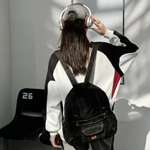 Black denim backpack detail, vintage multi-pocket design, stylish casual everyday carry bag.
