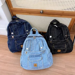 Vintage denim backpack for women, casual school bag with multiple pockets and stylish design.
