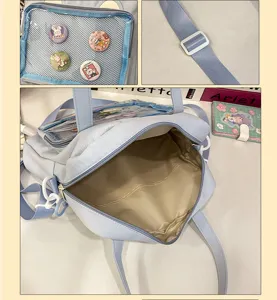 Light blue ita bag shoulder cross body bag with clear front pocket and cute pins for students.