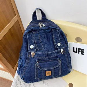 Vintage dark blue denim backpack for women, casual stylish school bag and travel daypack.