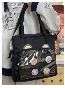 Black canvas ita bag with transparent front pocket, cute bear ears and badge display window.