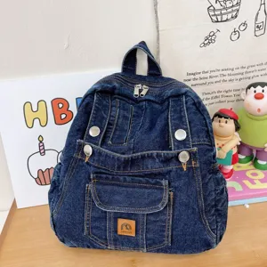 Detail view of vintage denim backpack for women, stylish casual canvas school bookbag with multi pockets.